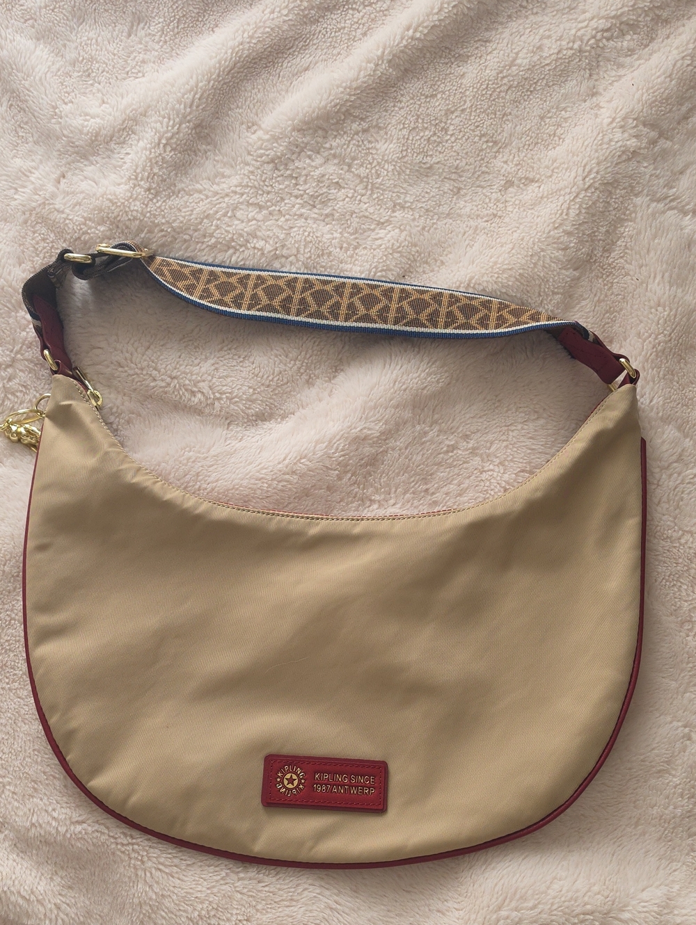 Kipling Beige Hobo Shoulder Bag with Red Trim and Patterned Strap